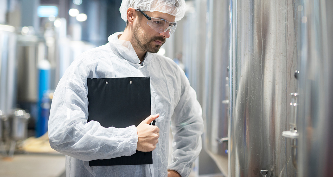 Mann prüft Wassertank in der Produktion