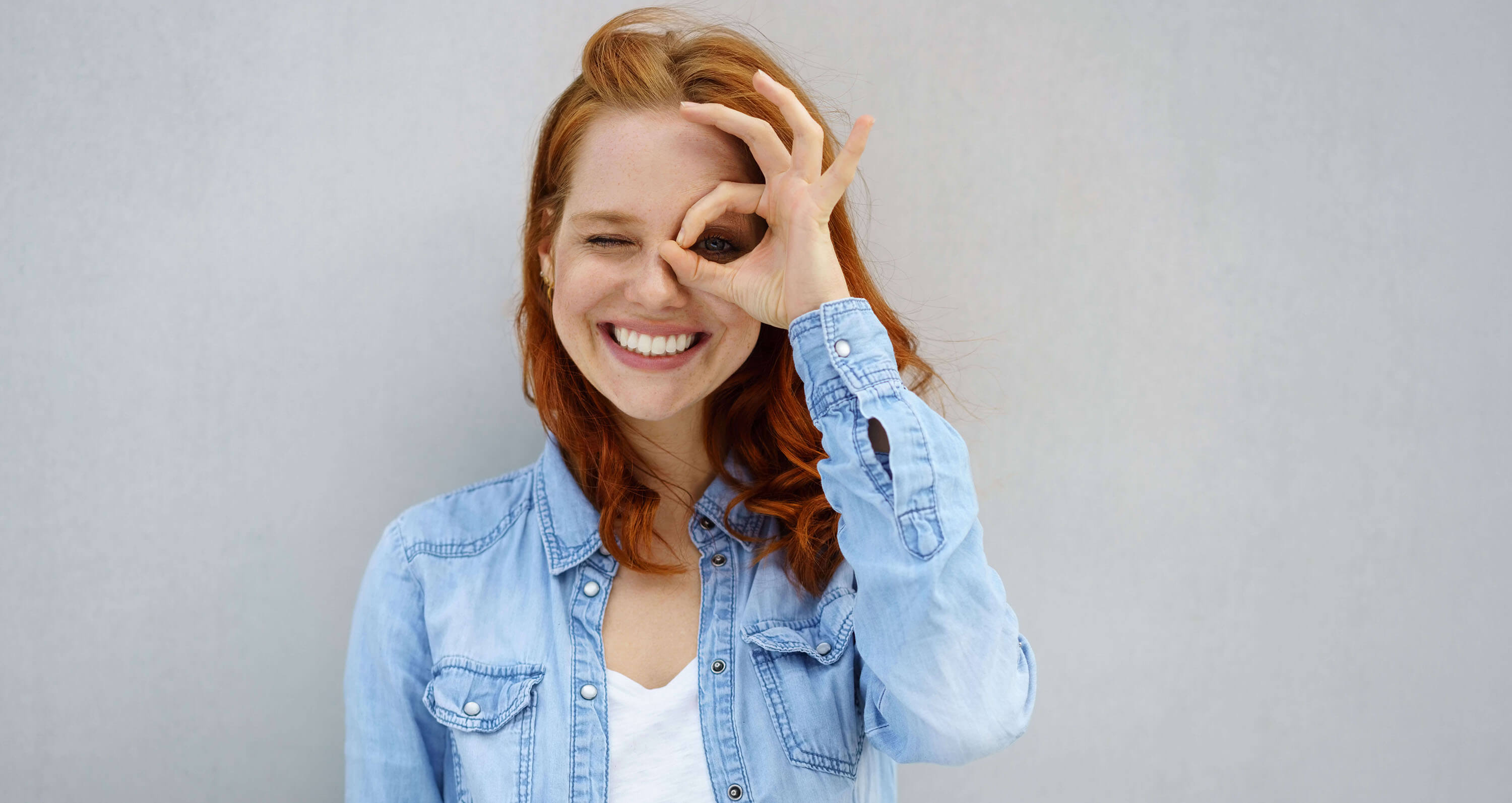 Rothaarige Frau mit blauer Jeansbluse